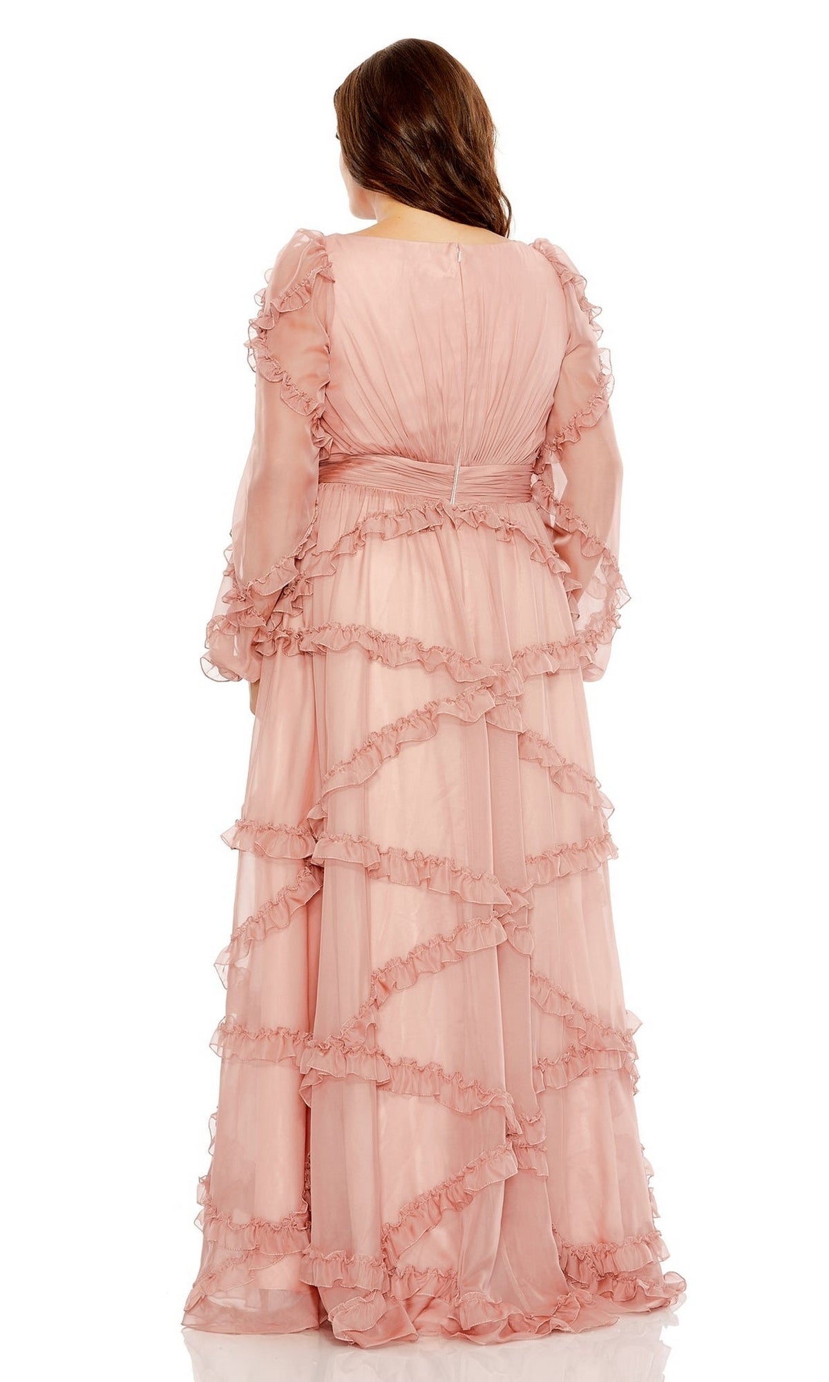 A woman is seen from the back wearing the Long Plus-Size Prom Dress 68425 by Mac Duggal in light pink, featuring long sleeves and delicate ruffles.